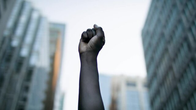 Raised black man's fist in protest. Social justice and peaceful protesting racial injustice. Shot in 4k.