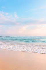 Poster Zandstrand, blauwe bewolkte lucht en zachte oceaangolf met warm zonsonderganglicht. © Oleandra9