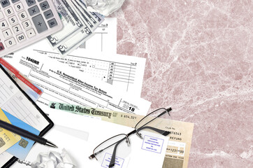 IRS form 1040NR Nonresident Alien Income tax return lies on flat lay office table and ready to...