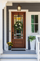 brown front door with flowers