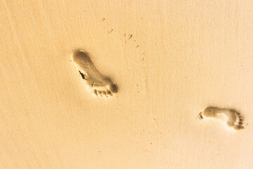 Footprints close-up in the sand of beach or dune in desert 