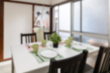 Blurred photo of house dining room with bright light