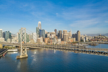 Obraz premium Aerial view of the San Francisco, California, skyline at sunrise. Ample copy space in blue sky. Bay bridge in foreground.