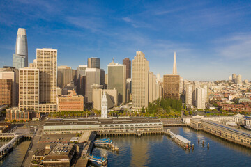 Fototapeta na wymiar Aerial daytime view of the San Francisco skyline, near the Embarcadero area. Ferry building is visible in foreground, plenty of copy space in blue sky