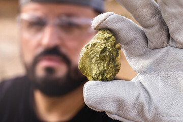 miner holding gold nugget, point focus on the gemstone. Mineral exploration concept, Minnesota,...