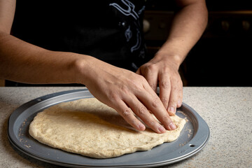 Fototapeta premium Male hands preparing homemade pizza