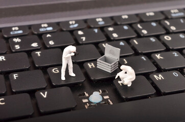 The figure of Crime Scene Investigation on keyboard. Cyber crimes concept. Selective focus.