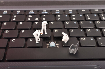 The figure of Crime Scene Investigation on keyboard. Cyber crimes concept. Selective focus.