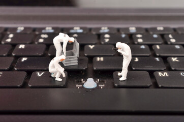 The figure of Crime Scene Investigation on keyboard. Cyber crimes concept. Selective focus.