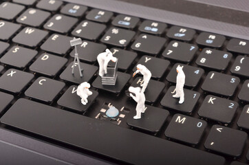 The figure of Crime Scene Investigation on keyboard. Cyber crimes concept. Selective focus.