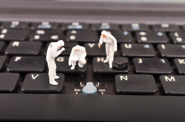 The figure of Crime Scene Investigation on keyboard. Cyber crimes concept. Selective focus.