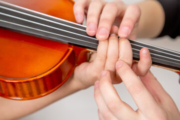 music school, teaching children to play the violin