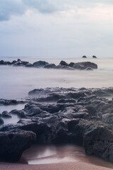 stones and waves on a beach of the pacific ocean