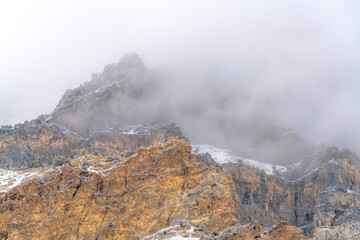 Misty clouds over the rugged peak of rocky mountain in Provo Canyon Utah