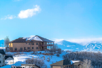 Homes on snowy terrain with panoramic views of Wasatch Mountain and valley