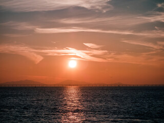 A hazy view of the sunrise over the sea