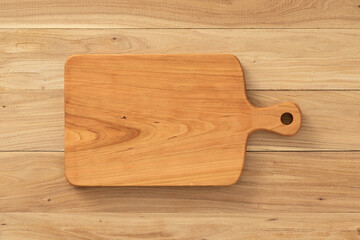 Handmade cherry wood chopping board on elm table top.