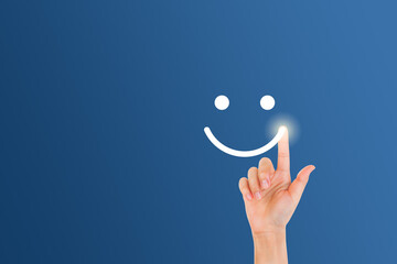 Customer Feedback Concept : Woman finger touch on smiley emotional symbol.