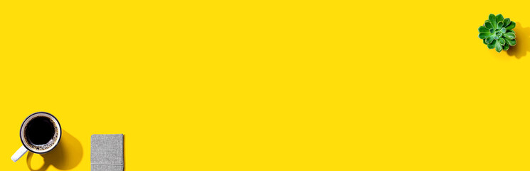 A cup of coffee and a notebook - flat lay