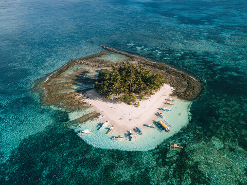 Aerial photos of Guyam Island, a tear-drop shaped island in the Philippine Sea situated around 2 kilometres south-southeast of General Luna municipality. Popular stop for tourists doing island-hopping