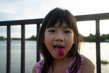 Asian child cute girl red tongue after Eat ice cream © akachai studio