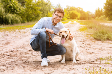 Excited man and his golden retriever walking outdoors