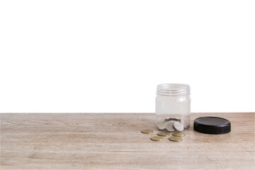 A​ few​ coins in​ jar on wooden table for​ collect money in future isolated on white background