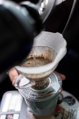 coffee pouring water brewing with filter with a plastic thermal water bottle inside a car with beautiful light and depth of field