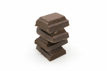 Broken black chocolate bar isolated on white background
