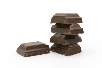 Broken black chocolate bar isolated on white background