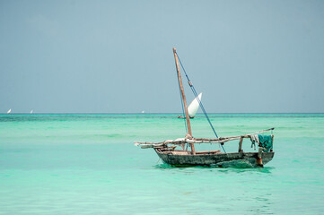 Wooden fisherman boat in the ocean in Zanzibar