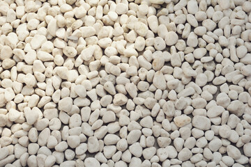 white pebbles stone texture background. Naturally polished white rock pebbles background
