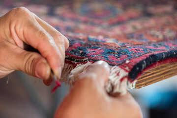 traditional hand sewing fixing old vintage antique persian carpet up close