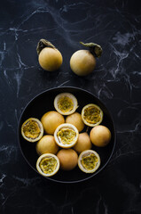 Wild passion fruits on dark background