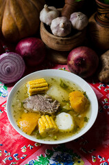 Fototapeta na wymiar Panamanian meat soup, made with a variety of vegetables, roots and condiments like cassava, sweet corn, yam, squash, culantro, onion, garlic and others 