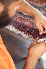 traditional hand sewing fixing old vintage antique persian carpet up close