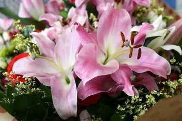 Pink lily flowers in a bouquet. Natural flowers. Table decoration