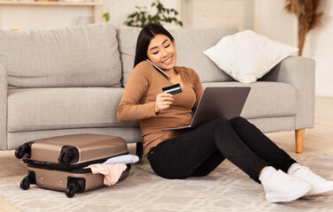 Obraz premium Woman Talking On Phone Holding Credit Card Sitting At Home