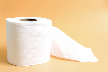 Roll of toilet paper or tissue on latte color background