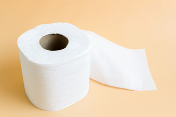 Roll of toilet paper or tissue on latte color background