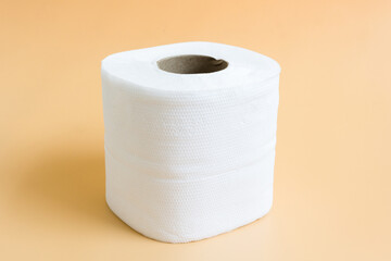 Roll of toilet paper or tissue on latte color background