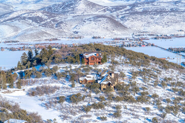 Beautiful mountain terrain in Park City Utah with homes amid snow and trees