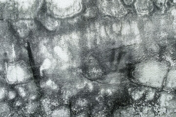 Grunge cracked concrete wall texture background. Old white dirty wall with black stains from mold...