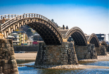 Kintaikyo Bridge at Iwakuni, Yamaguchi, Japan. It is a wooden bridge with sequential arches