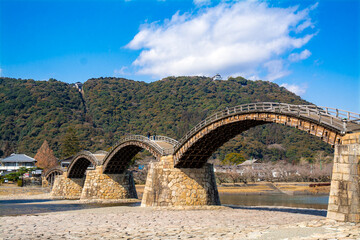 Kintaikyo Bridge at Iwakuni, Yamaguchi, Japan. It is a wooden bridge with sequential arches