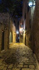 Fototapeta na wymiar White stone house on narrow street of Old Yafo (Jaffa) at night. Tel Aviv, Israel.