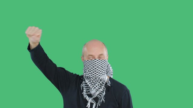 Protester man in checkered bandana at demonstration on green chroma key background. Bald man with fist hand chanting on social revolution. People riots and uprisings
