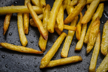 french fries on a pan background