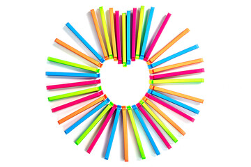 Colored plastic food bag clippers put in heart shape isolated on white background