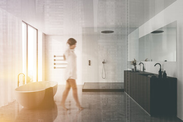 Obraz na płótnie Canvas Woman walking in luxury white bathroom